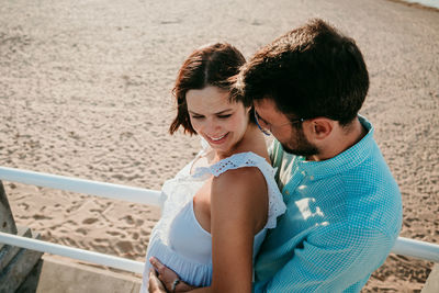 Couple embracing while standing on beach