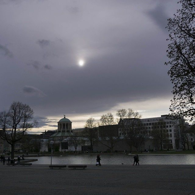 architecture, built structure, building exterior, sky, cloud - sky, tree, cloudy, bare tree, weather, city, cloud, silhouette, incidental people, travel destinations, outdoors, overcast, building, dusk, day