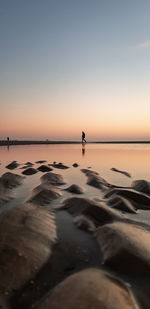 Scenic view of beach against sky during sunset