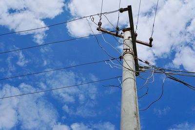 Low angle view of telephone pole against sky