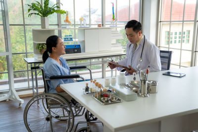 Female doctor examining patient at clinic