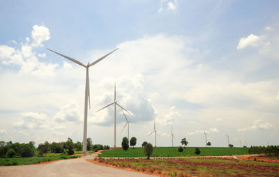 Windmill on field against sky