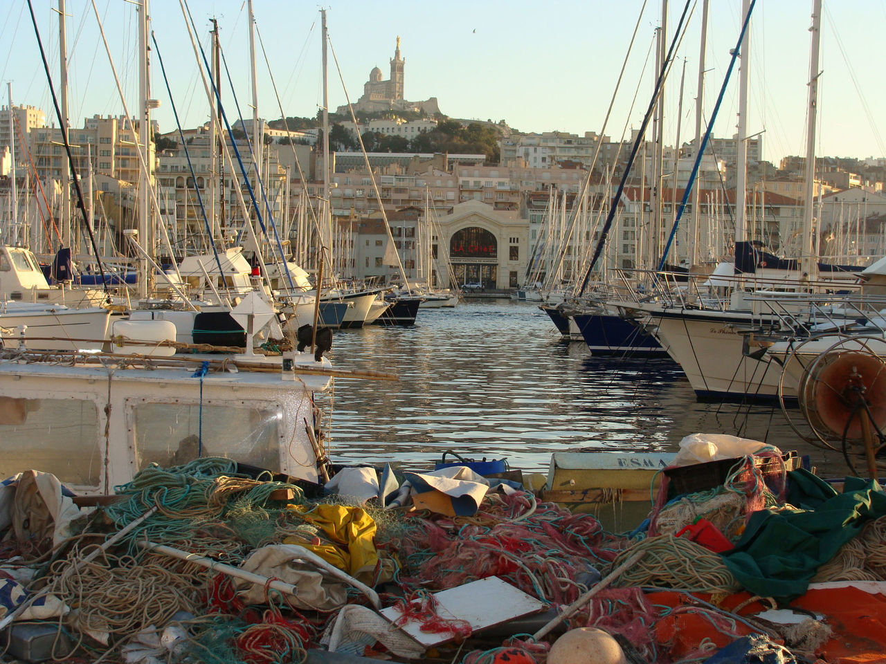 BOATS MOORED AT RIVER AGAINST SKY