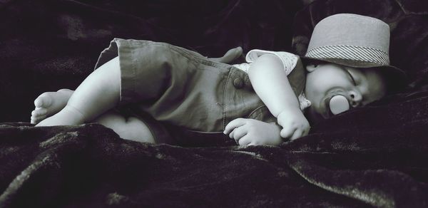 Close-up of baby boy sleeping on bed