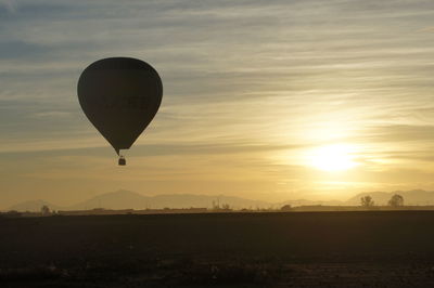 Hot air balloon against sky during sunrise