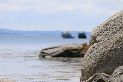 Rocks on beach against sky