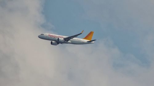 Low angle view of airplane flying in sky