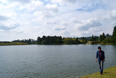 Full length of man on lake against sky