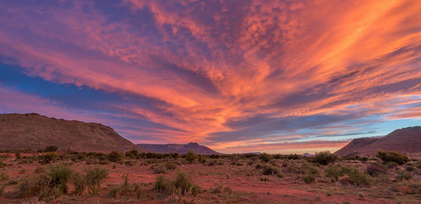 Scenic view of desert against sky during sunset