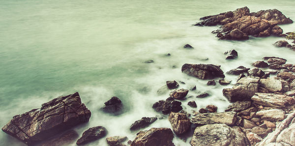 High angle view of rocks in sea