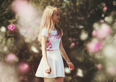 Young girl standing in garden