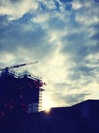 Low angle view of building against cloudy sky