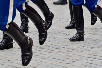 Low section of people in costume on road