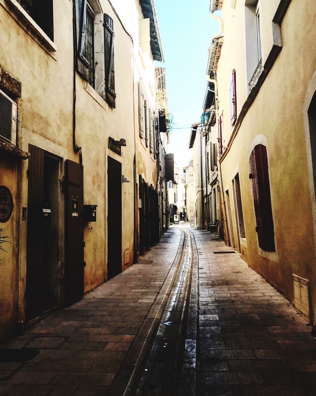 EMPTY ALLEY AMIDST BUILDINGS