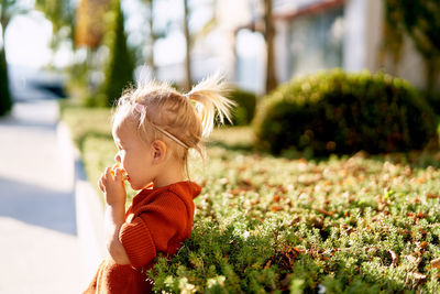 Side view of cute baby girl outdoors
