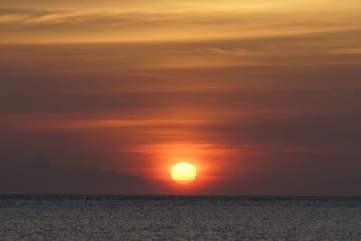 Scenic view of sea against romantic sky at sunset