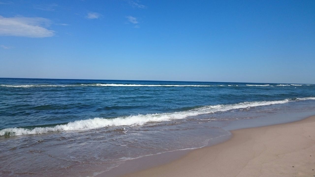 sea, beach, horizon over water, water, wave, shore, scenics, surf, sand, beauty in nature, tranquil scene, blue, clear sky, tranquility, copy space, nature, idyllic, sky, motion, coastline