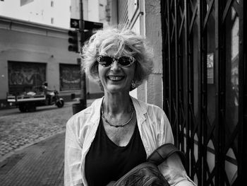 Portrait of smiling woman wearing sunglasses outdoors