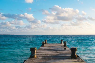 Pier over sea against sky