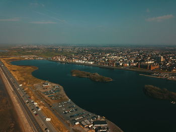 High angle view of river amidst buildings in city against sky