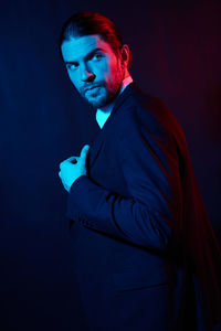 Portrait of young man against blue background