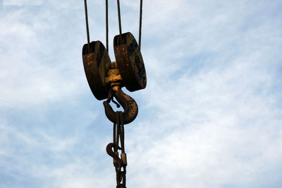 Low angle view of chain against sky