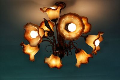 Close-up of lit candles on table against white background