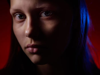 Close-up portrait of serious young woman at home