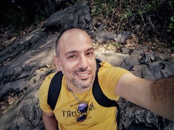 Portrait of smiling young man on rock