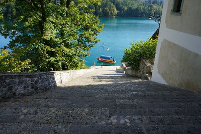 Lake bled is seem from the top of stair leading to the st marys church of assumption