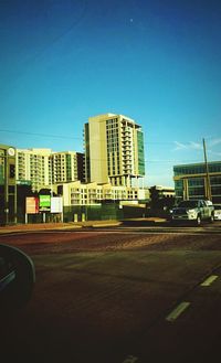 Buildings in city against blue sky