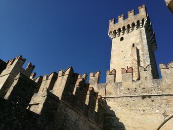 Low angle view of fort against blue sky