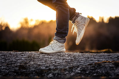 Low section of person standing on rock