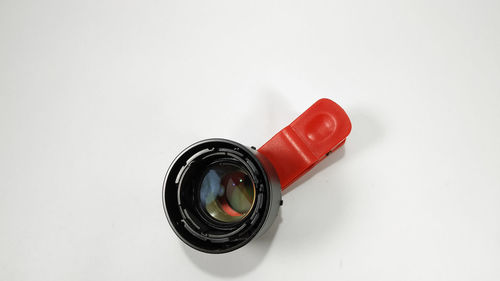 Close-up of camera over white background