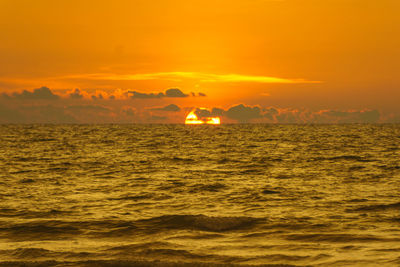 Scenic view of sea against romantic sky at sunset