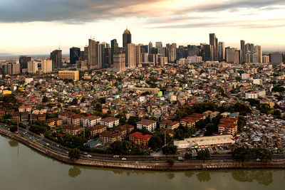 Aerial view of modern buildings against sky during sunset