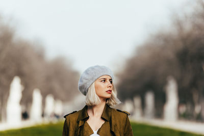 Portrait of young woman looking away in winter