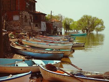 Boats in river with buildings in background