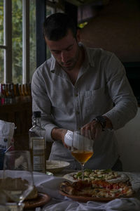 Young man cooking food at home