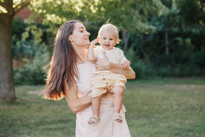 Happy mother and son standing outdoors