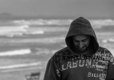 Portrait of mid adult man standing at beach