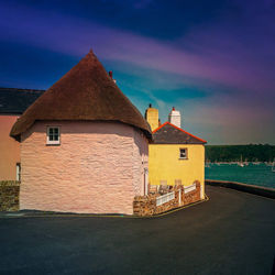 Houses against cloudy sky