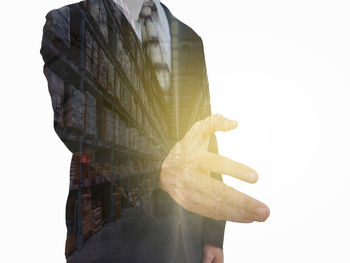 Digital composite image of hand against white background