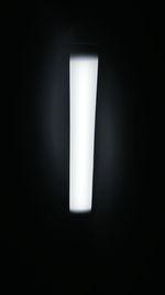 Close-up of illuminated lamp in darkroom