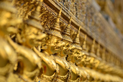 Close-up of golden statues at wat phra kaew