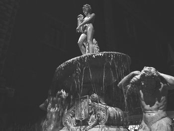 Low angle view of amenano fountain at night