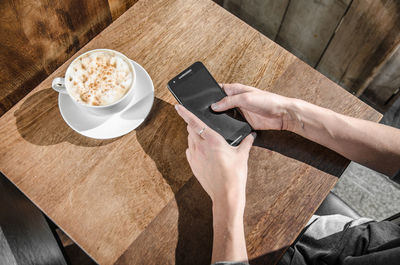 High angle view of woman using laptop on table