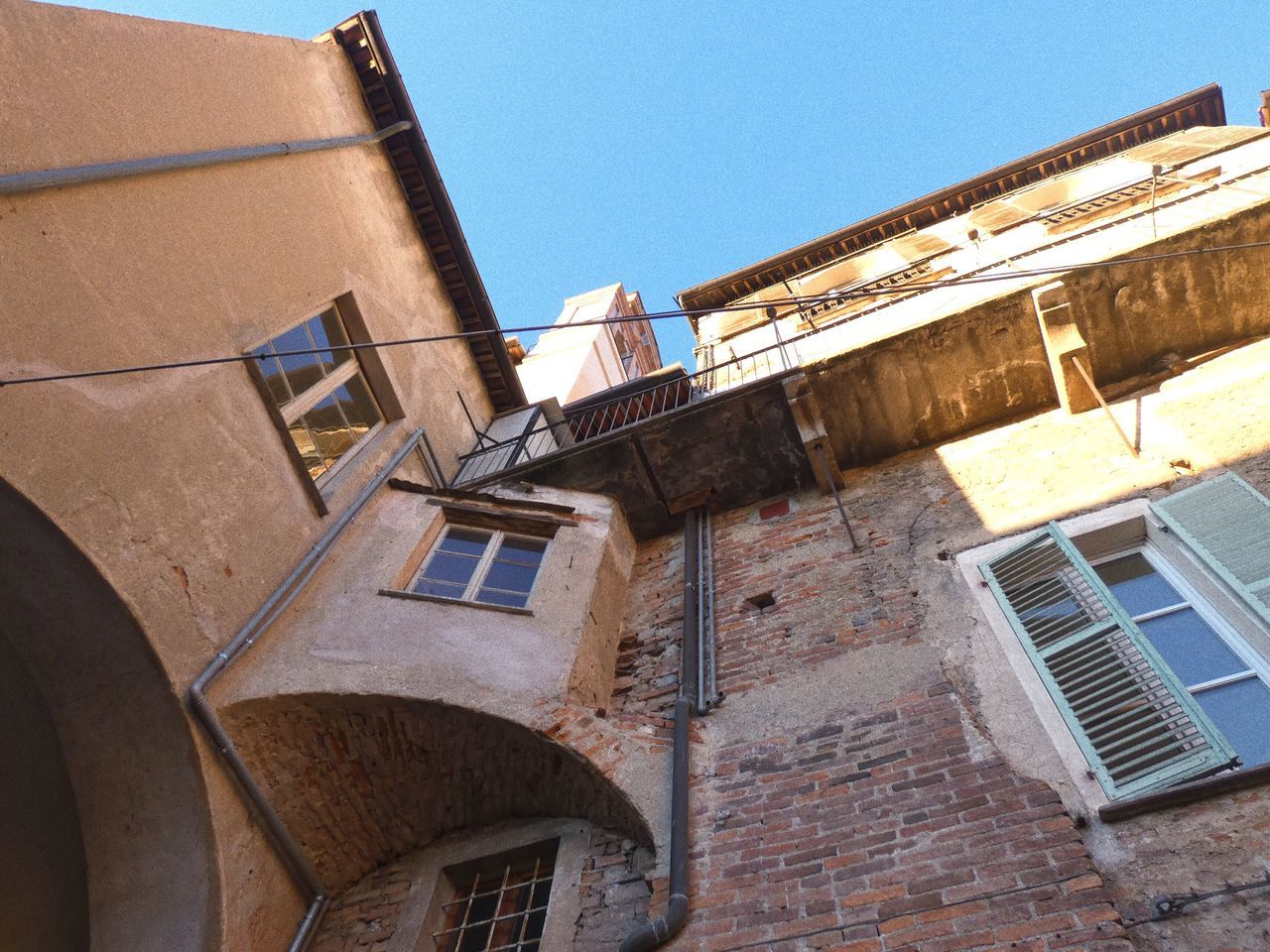 built structure, building exterior, architecture, building, sky, clear sky, low angle view, window, nature, old, day, no people, sunlight, residential district, wall, outdoors, industry, town, city, construction industry, location, place, neighborhood