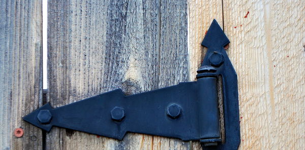 Low angle view of old metal door on wall