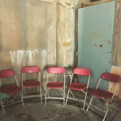 Red folding chairs in abandoned building